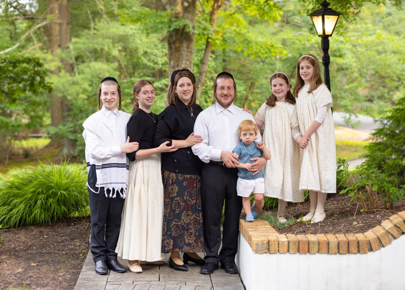 A family standing together in the garden