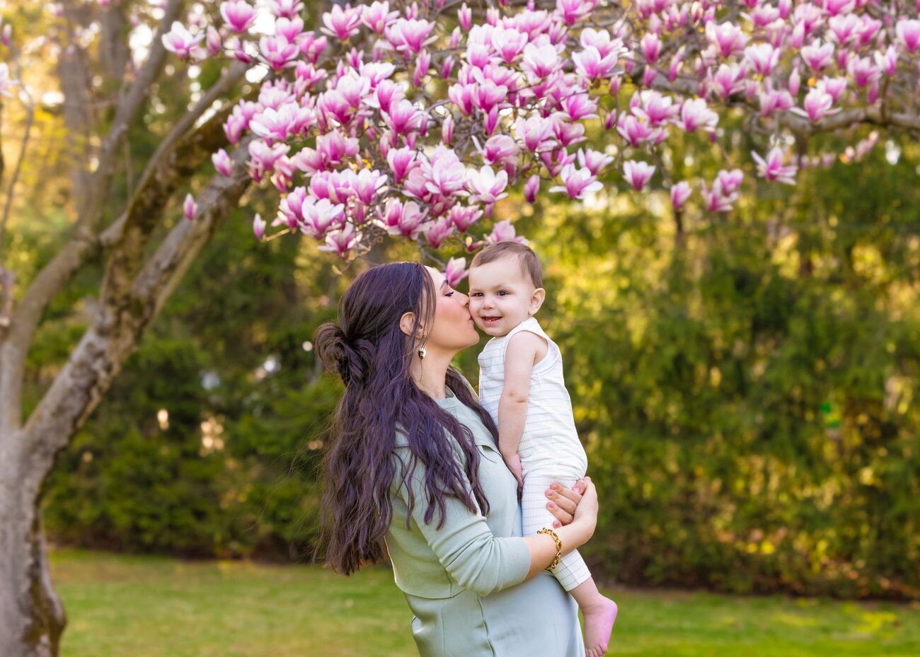 Mother and child under a pink magnolia