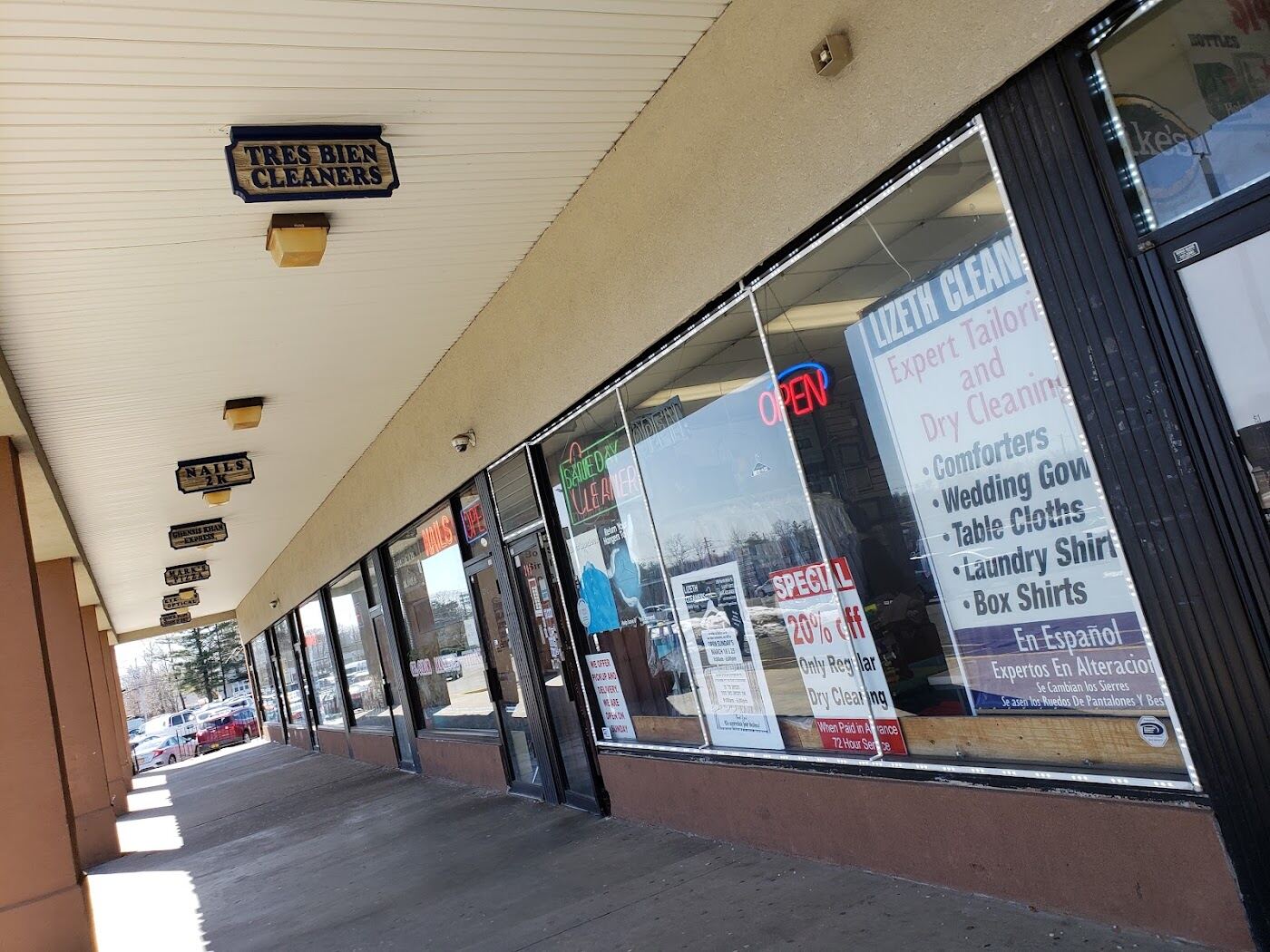 The Valley Cleaners window listing wedding gowns, table cloths, laundry shirts and box shirts