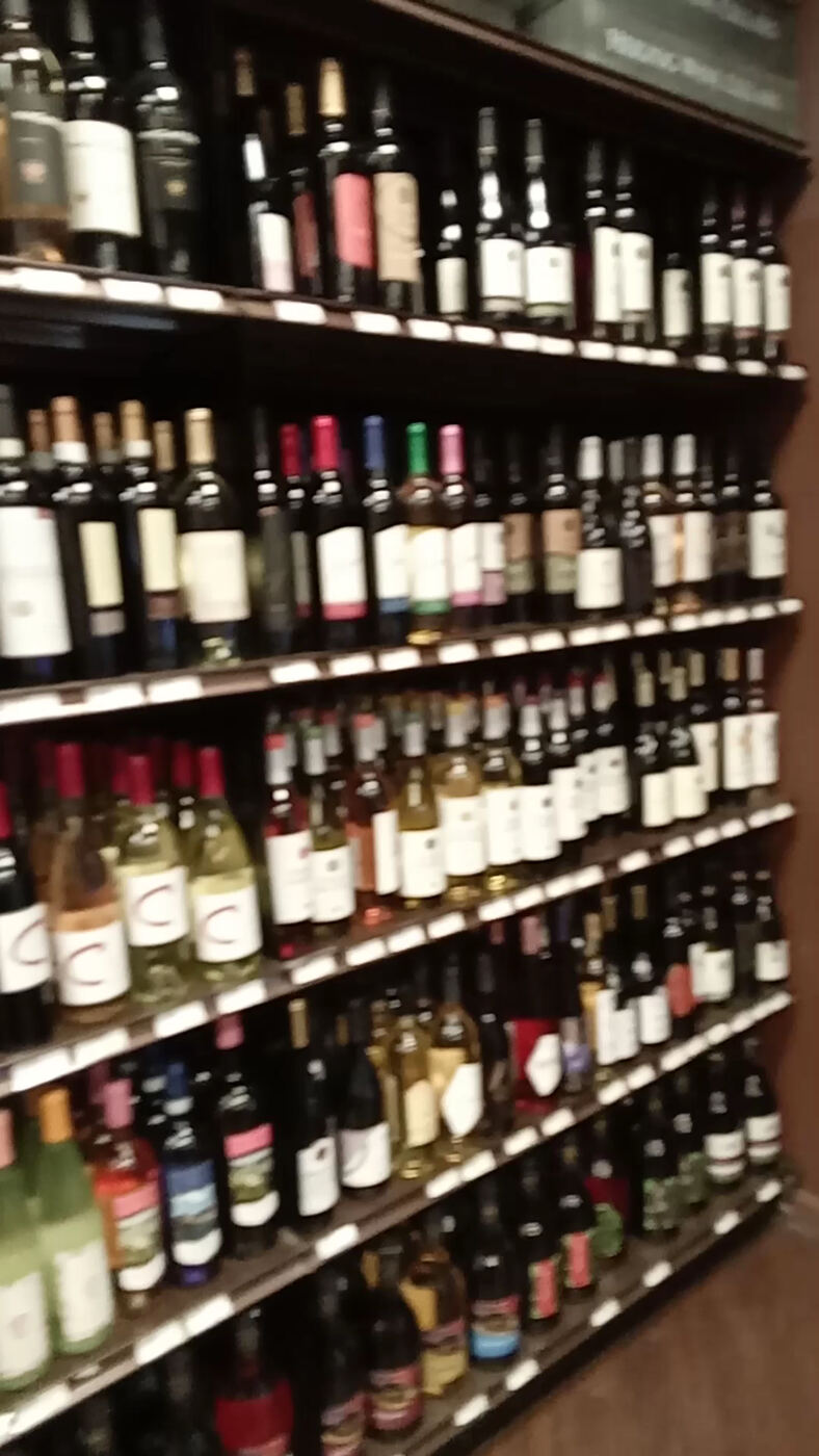 Floor-to-ceiling wine shelves at Wine On 59